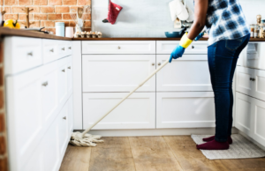 a person cleaning the kitchen